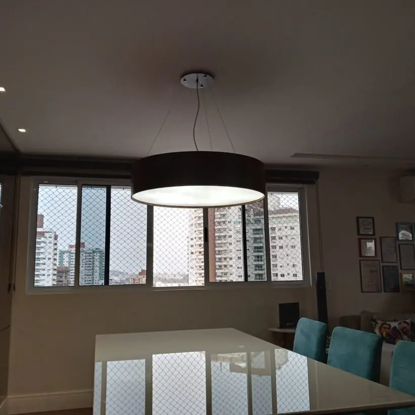 Pendente de cúpula instalado sobre mesa de vidro